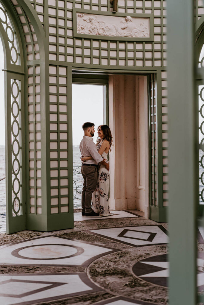 a couple hugs inside the gazebo of their engagement shoot