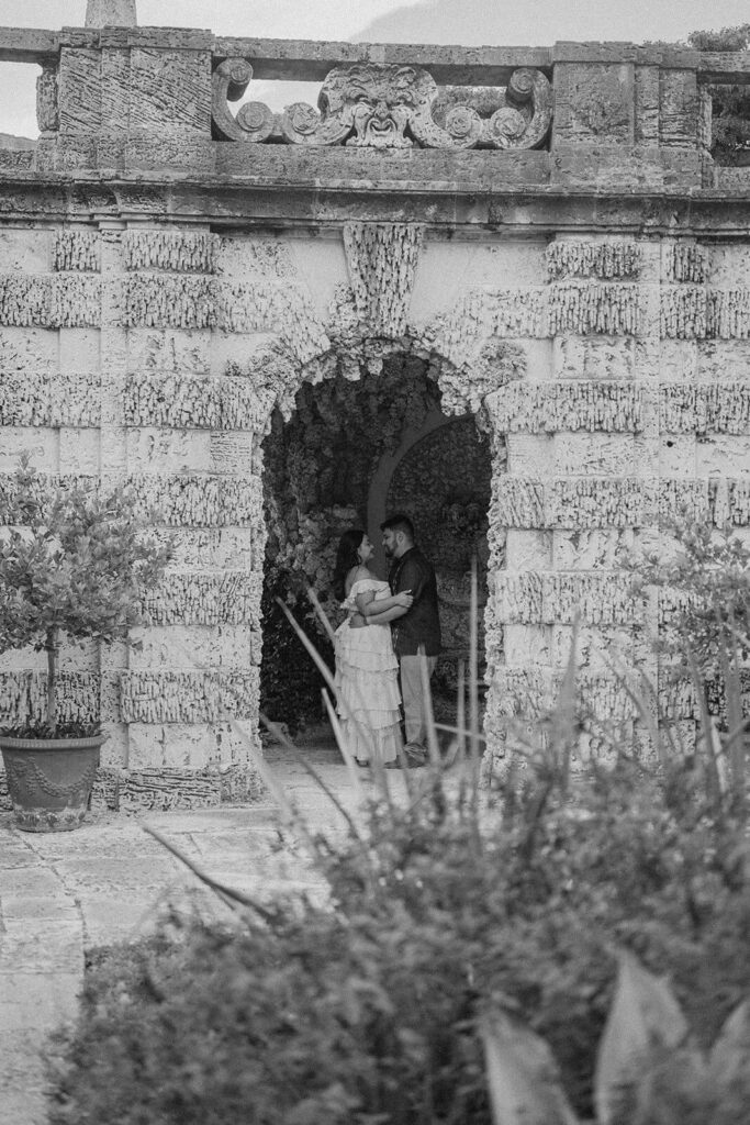 a couple standing inside a coral cave at Vizcaya in Miami