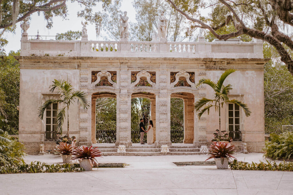a couple holds hands inside one of the architectural stunners at Vizcaya in Florida