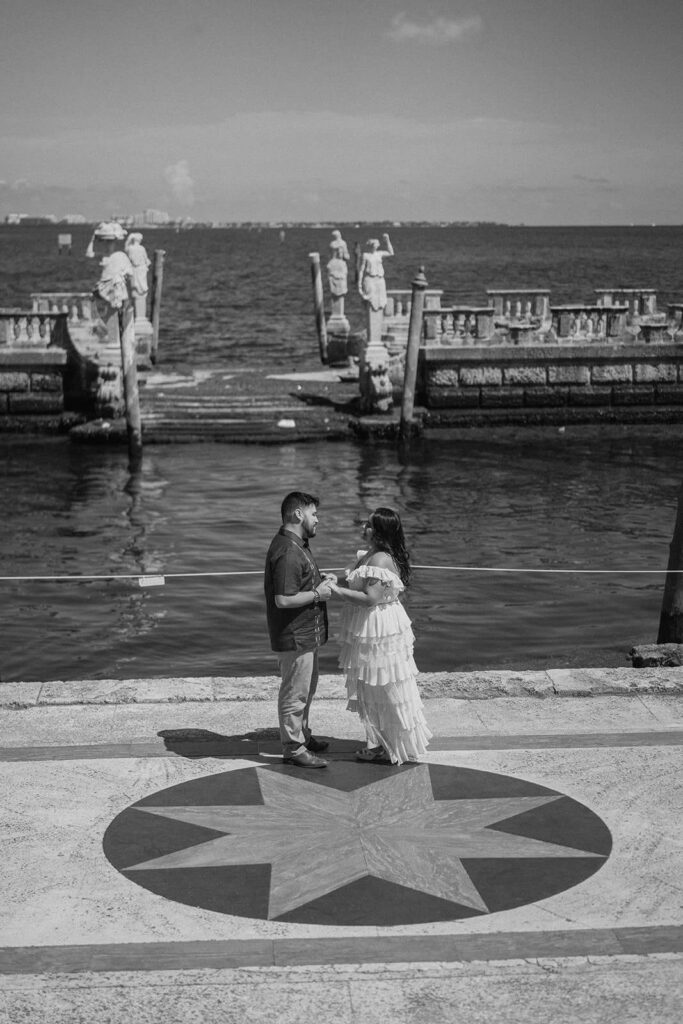 a couple poses in front of the stone boat in Miami
