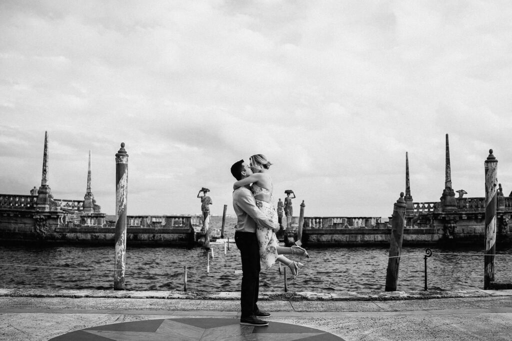 a man picks up his fiance in front of the stone boat in miami's vizcaya museum