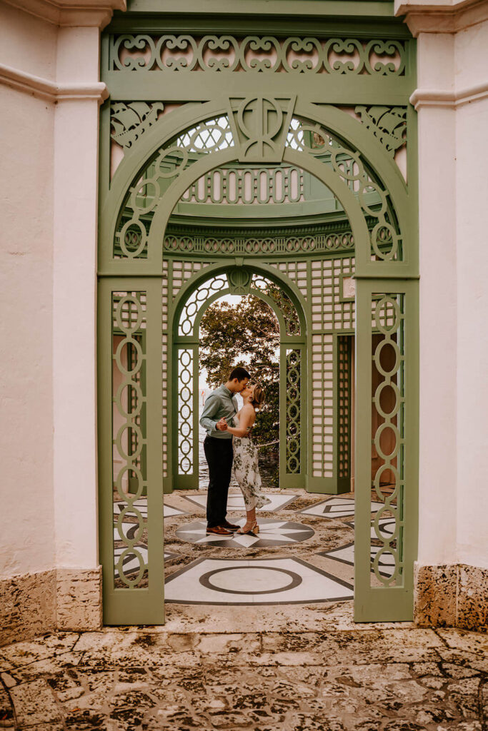 a man and his fiance kiss under the gazebo at Miami's Vizcaya