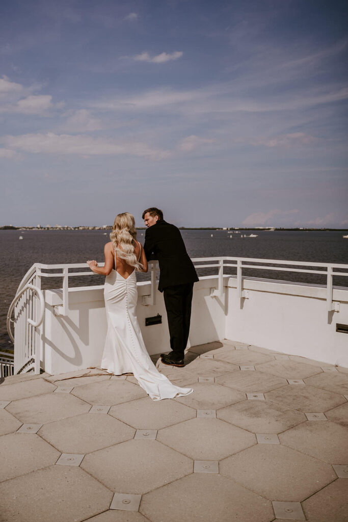 a bride and groom overlook the ocean water at their mansion luxury wedding in miami