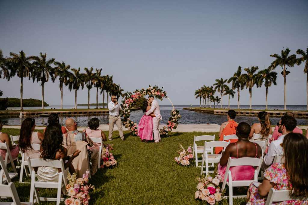 a bride and groom kiss at their ceremony at their miami wedding