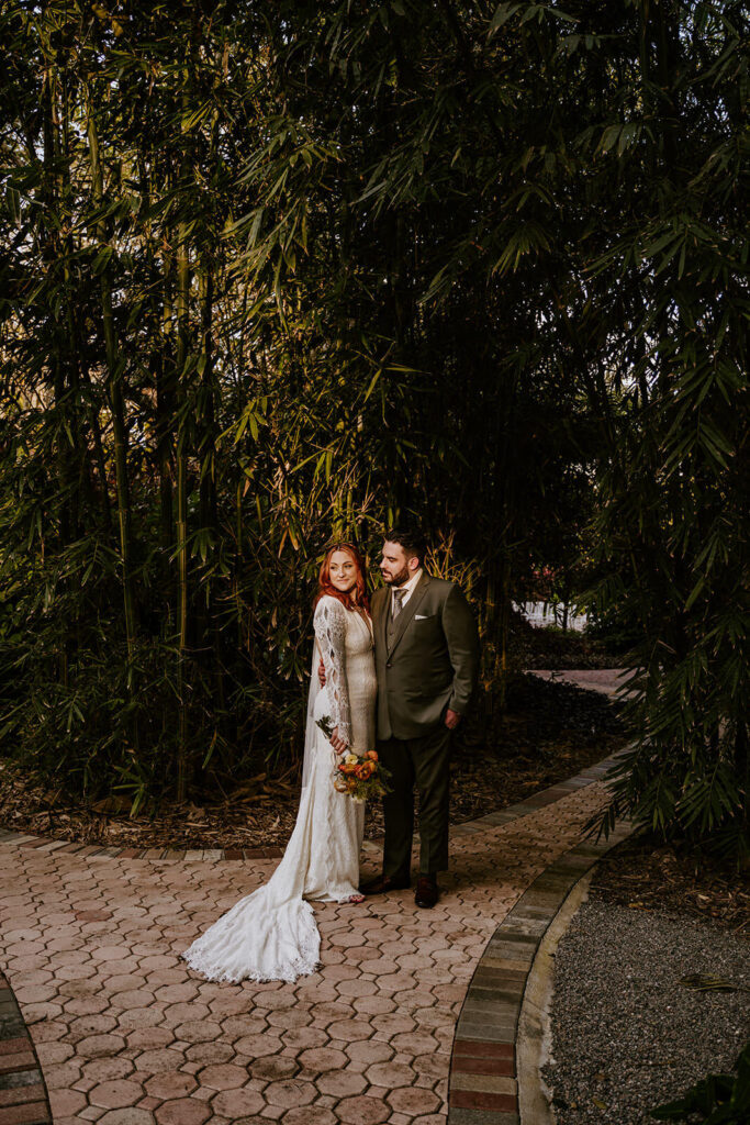 a couple poses in the golden sun at their spring time wedding in homestead florida