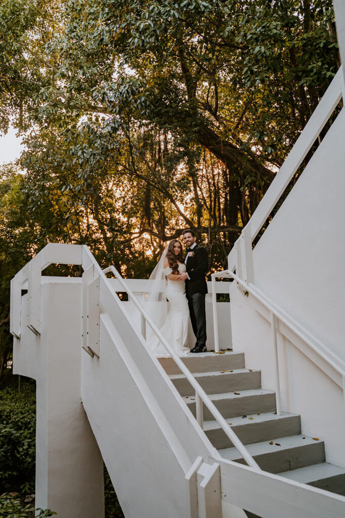 a couple poses on stairs at their Bakers Cay Resort wedding day