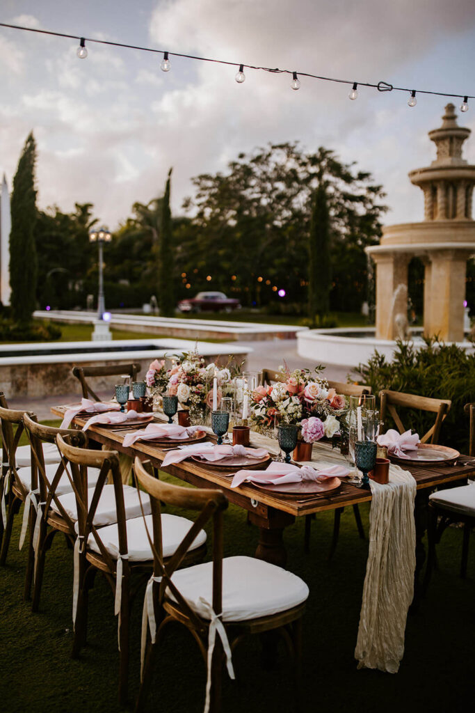 beautiful pink decor on a table at a wedding reception at a wedding at villa tosacana