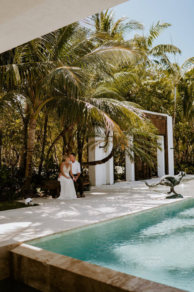 a couple hugging by the pool on their miami wedding day
