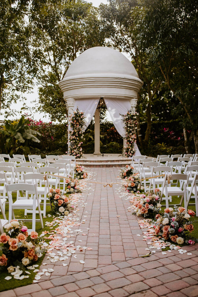 a ceremony space filled with flowers at villa toscana in south florida