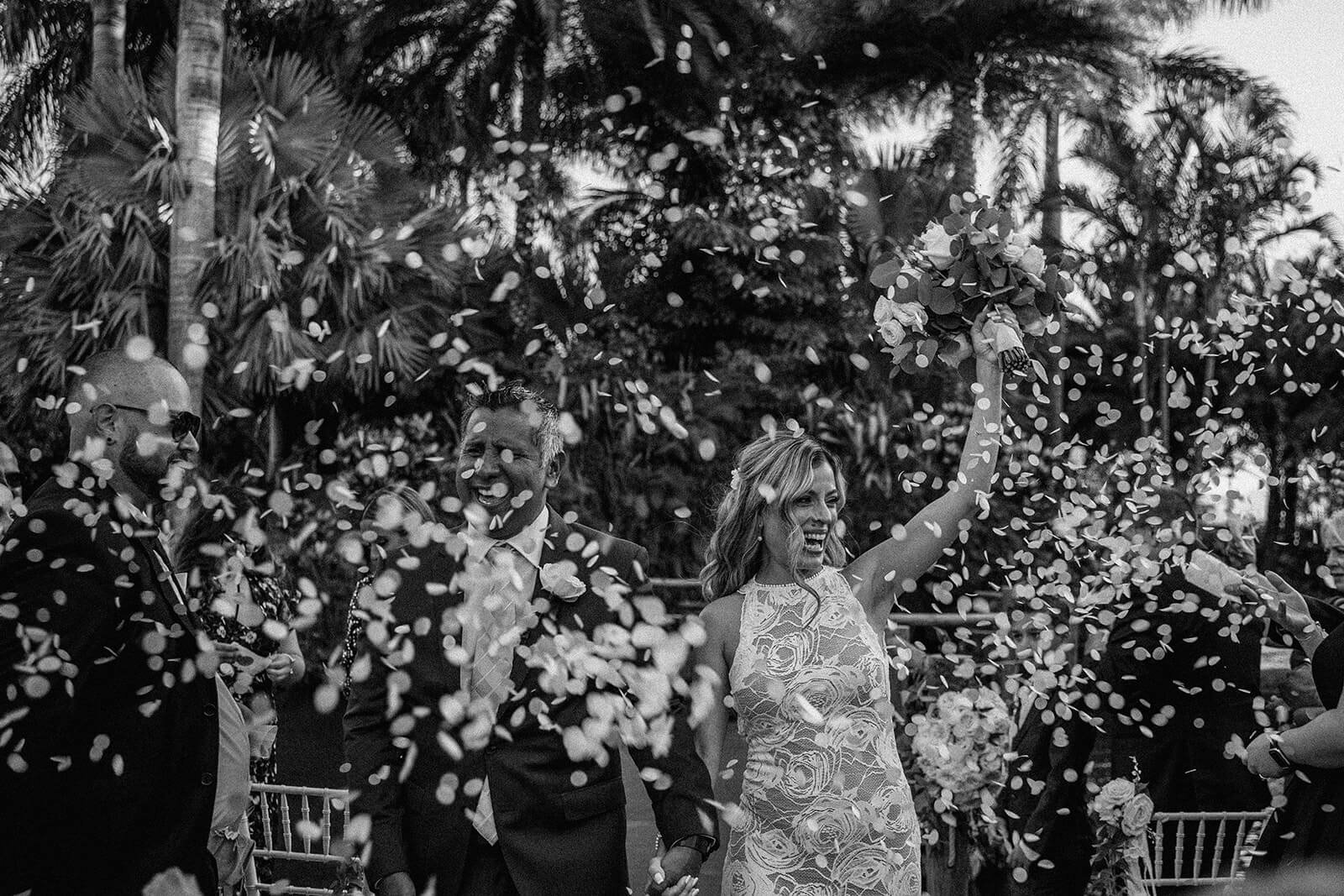 a couple is introduced as husband and wife for the first time on their wedding day as confetti is all around them at Longans Place