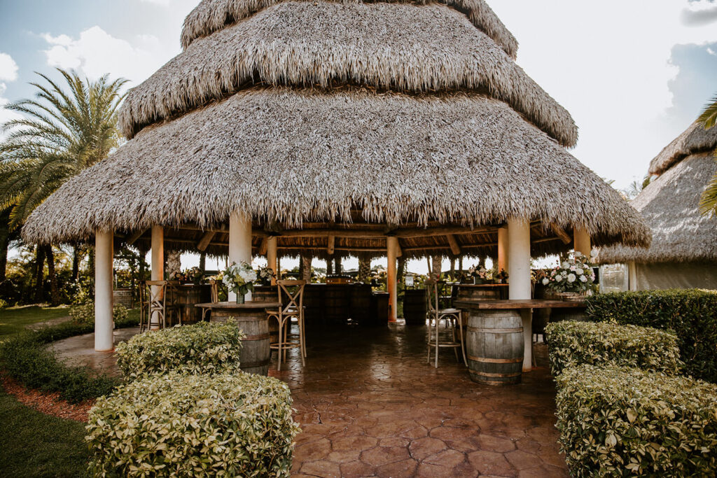 one of the large tiki huts that are used for the cocktail hour location at longans place in homestead