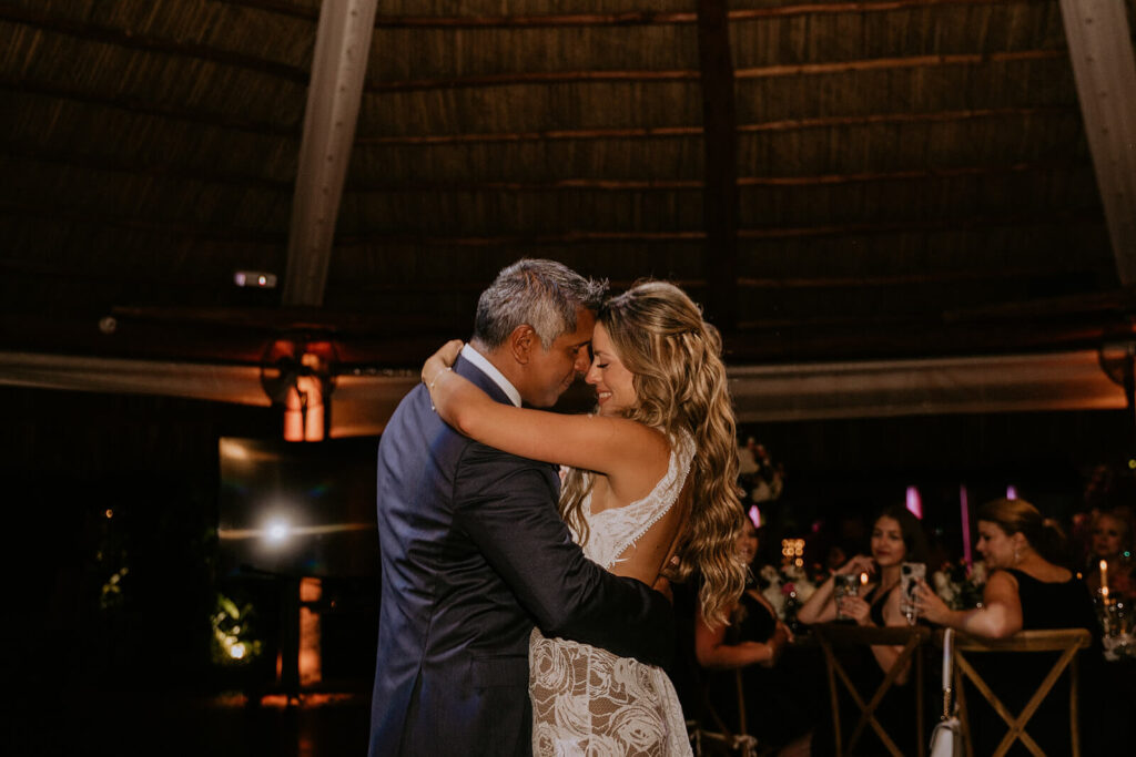 a bride and groom have their first dance as husband and wife at longans place