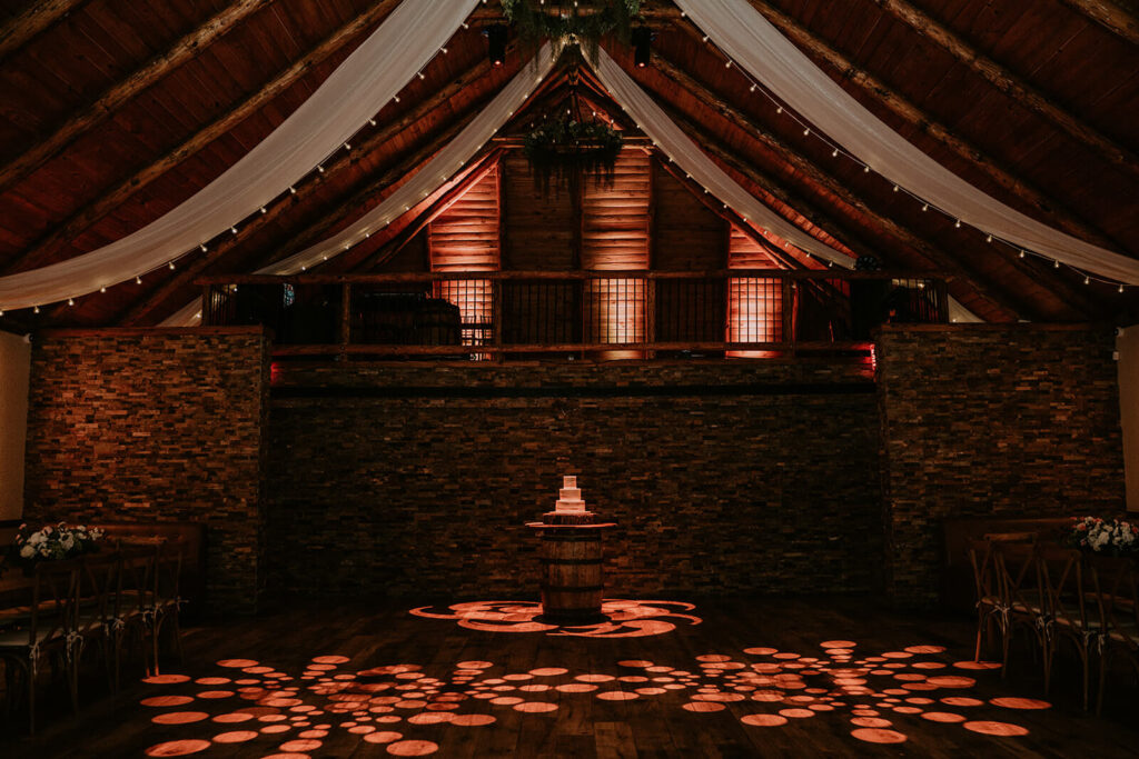 the barn where you dance empty with just the cake before the reception begins