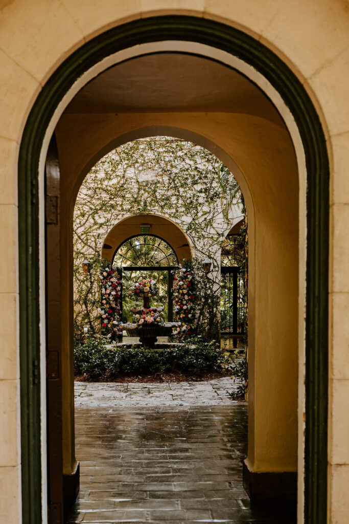 a photo of the fountain in the courtyard at Villa Woodbine through one of the arch doorways