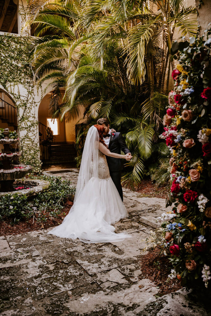 a couple shares their first dance as husband and wife in the courtyard of Villa Woodbine
