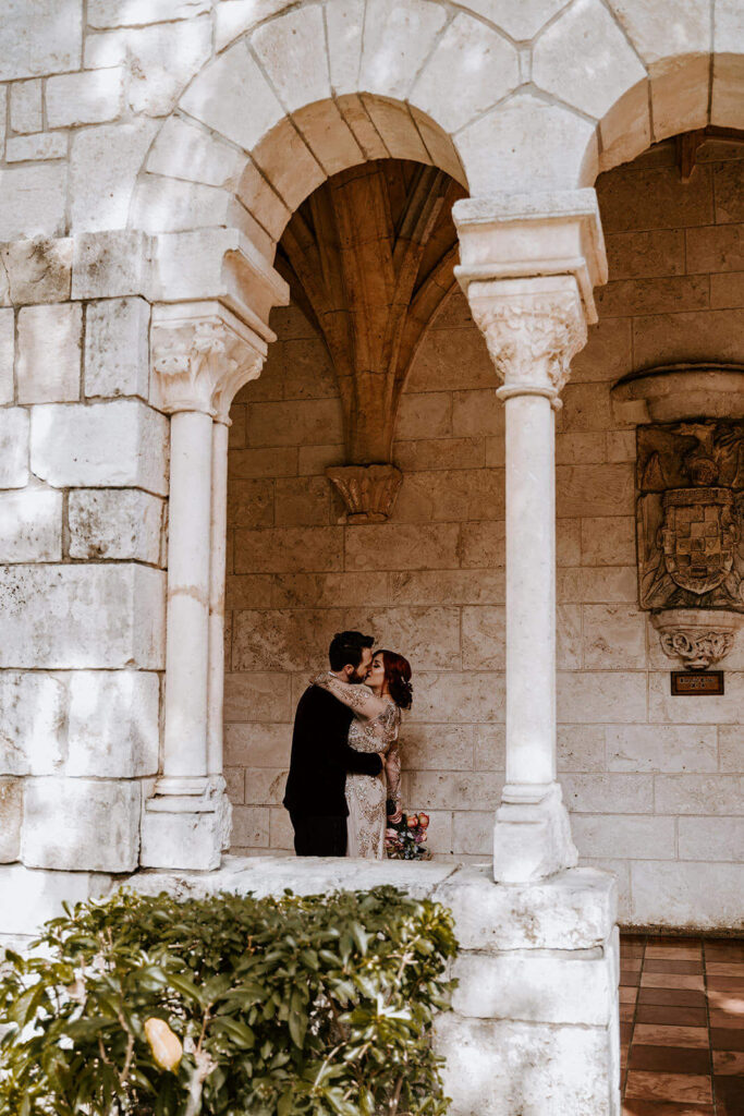 a couple kisses at their miami wedding venue