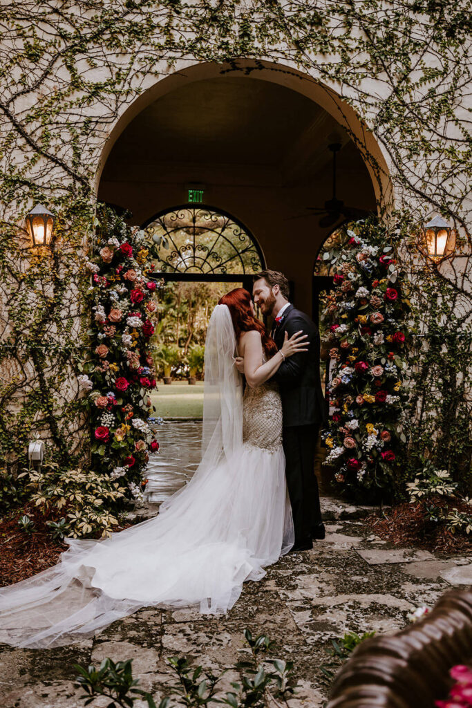 a couple has their first kiss on their wedding day at Villa Woodbine in Miami, Fl