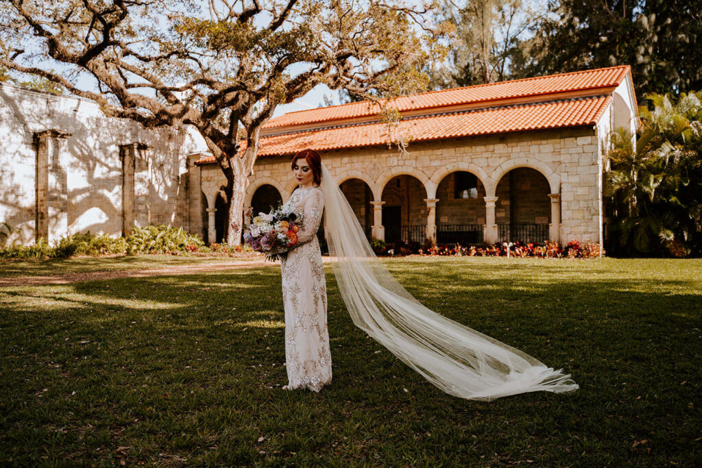 a bride standing in front of one of the best miami wedding venues - The Ancient Spanish Monastery