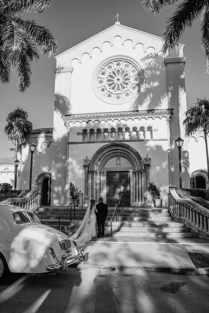 a bride and her father wait outside the church about to walk into her wedding ceremony at their miami wedding