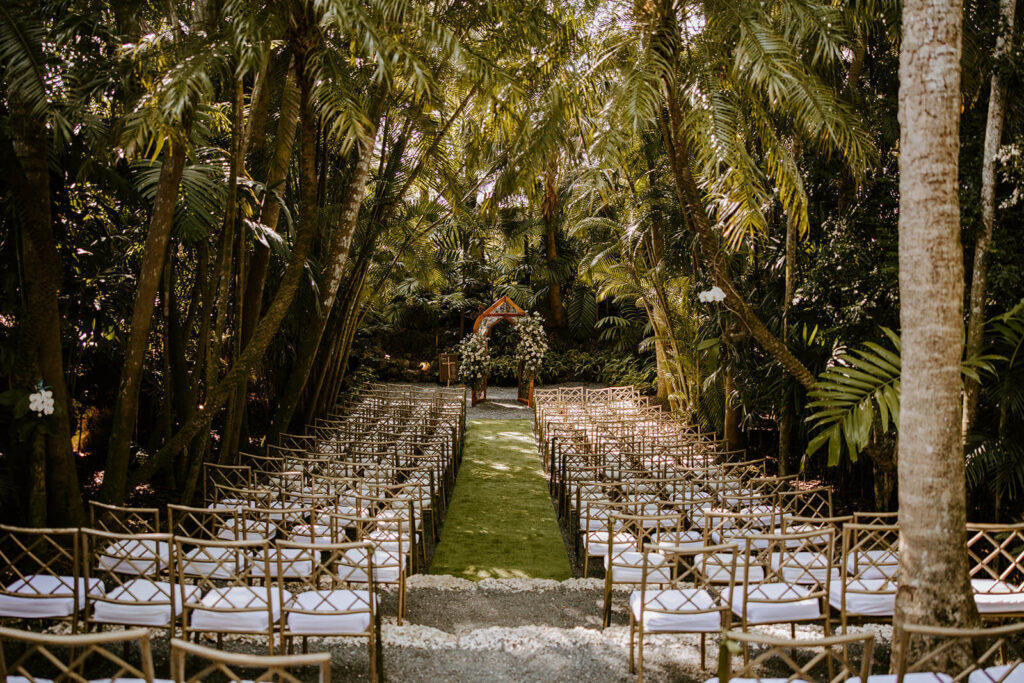 a ceremony set up at the Cooper Estate in Miami surrounded by tress and palms