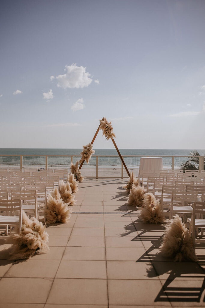 a boho ceremony set up on the balcony of a beachfront miami wedding venue