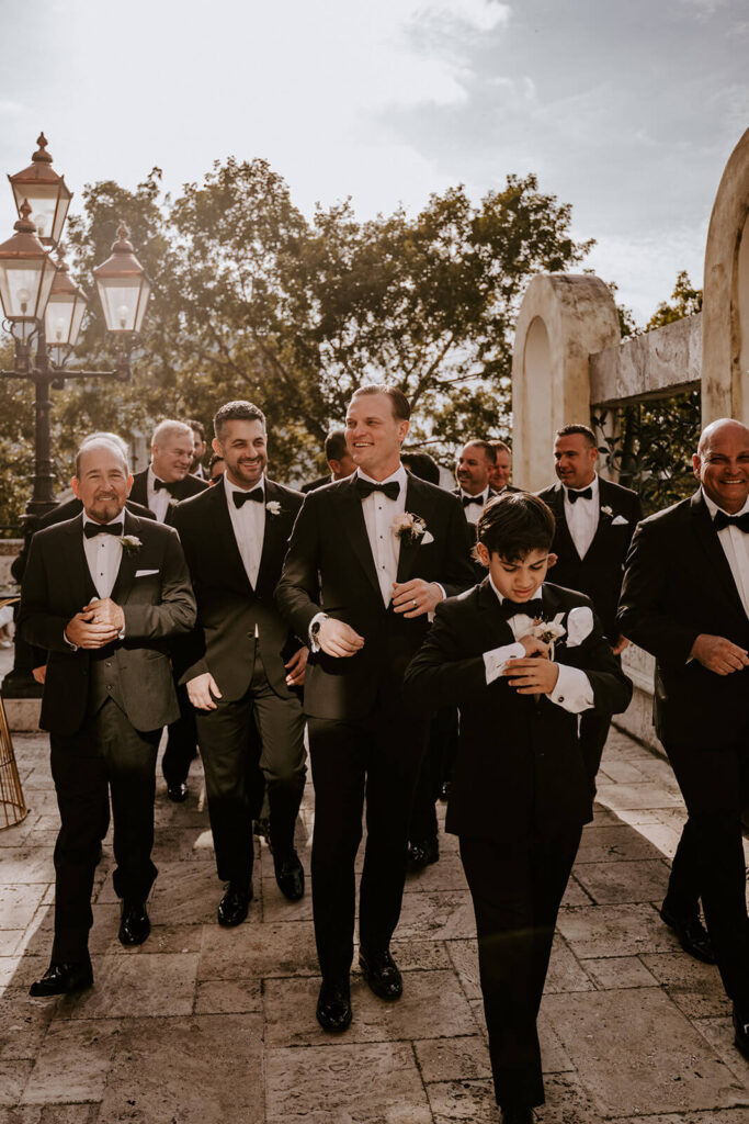 groomsmen walk at their wedding venue in Miami florida