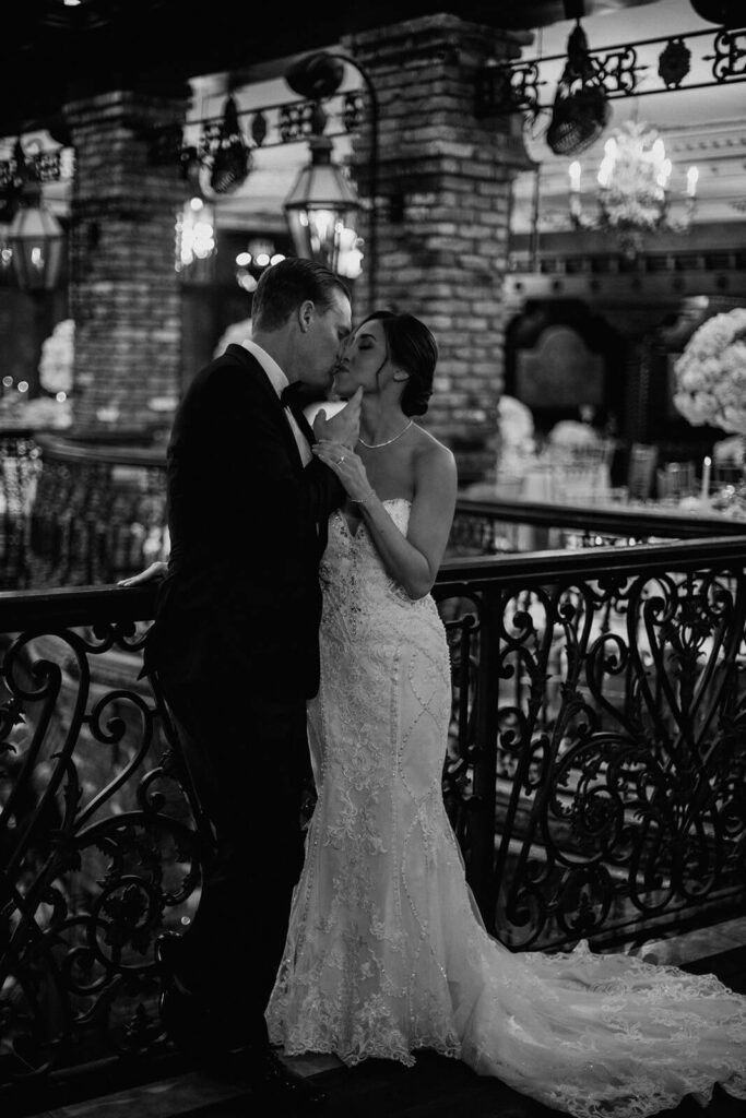 a couple kisses in their miami wedding venue the Cruz Building  on their wedding day