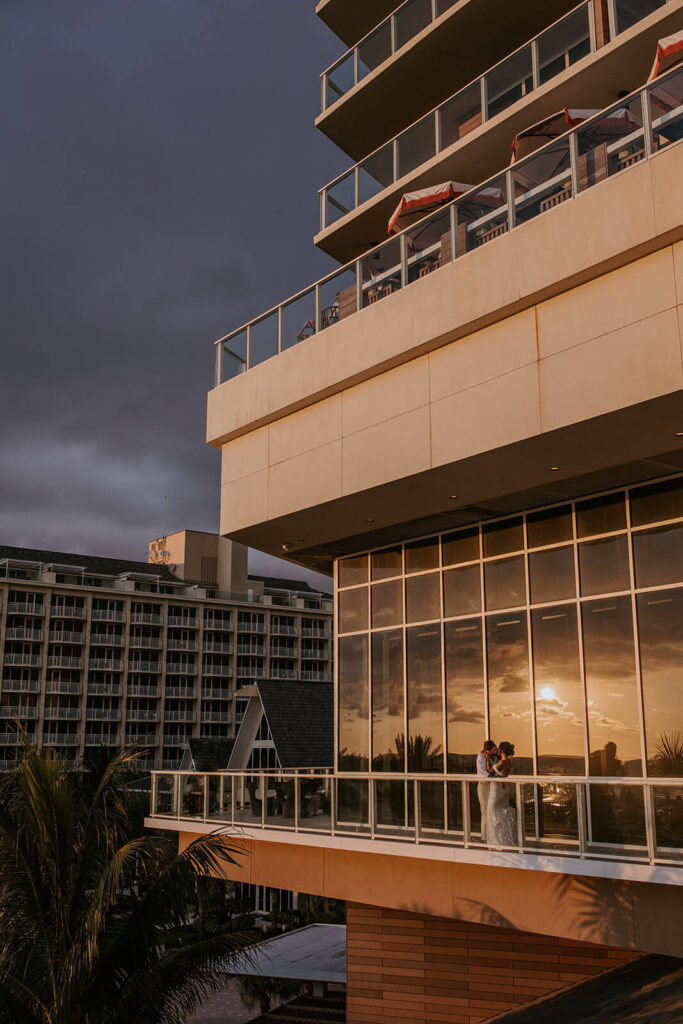 a couple kissing on a balcony of their hotel wedding venue in Miami 