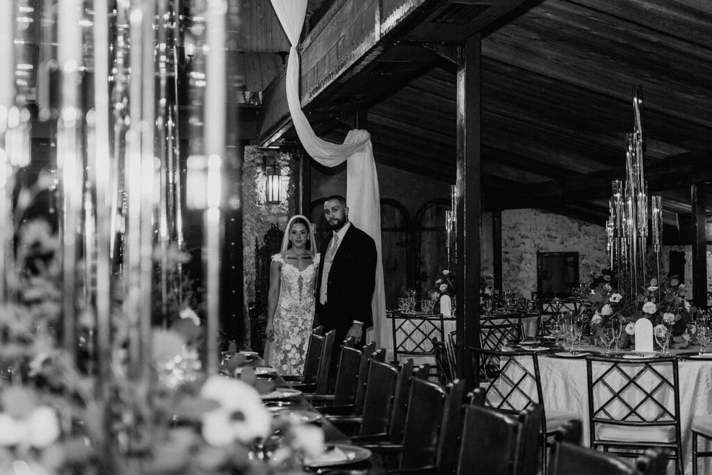 a couple poses while looking at the camera at The Cooper Estate in Miami on their wedding day