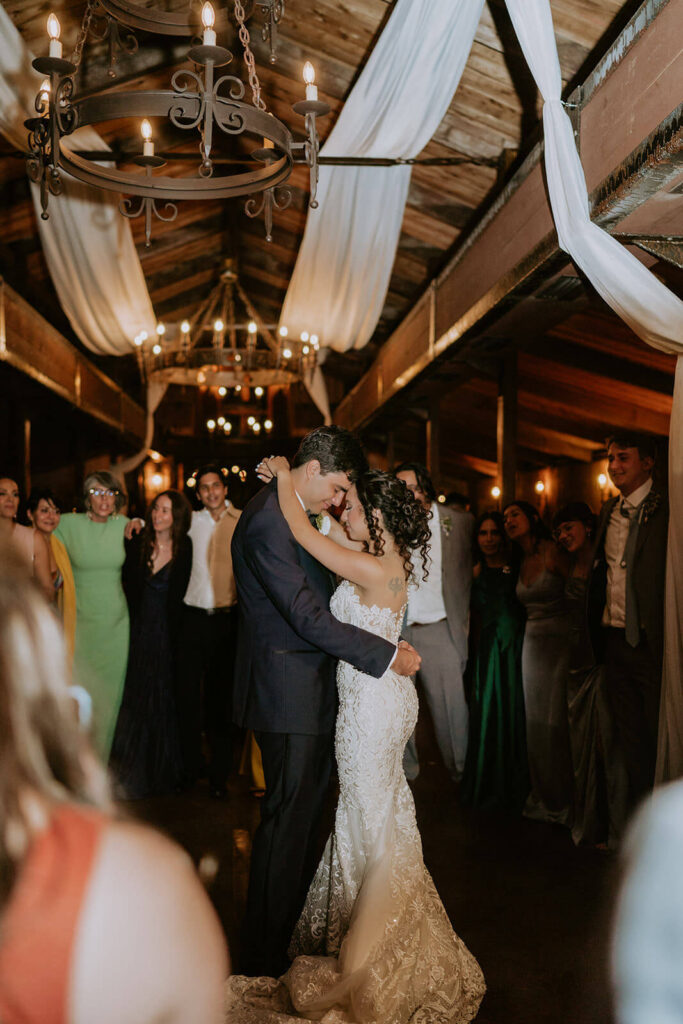 a bride and groom dance in the middle of a circle of their guests at The Cooper Estate in Miami fl