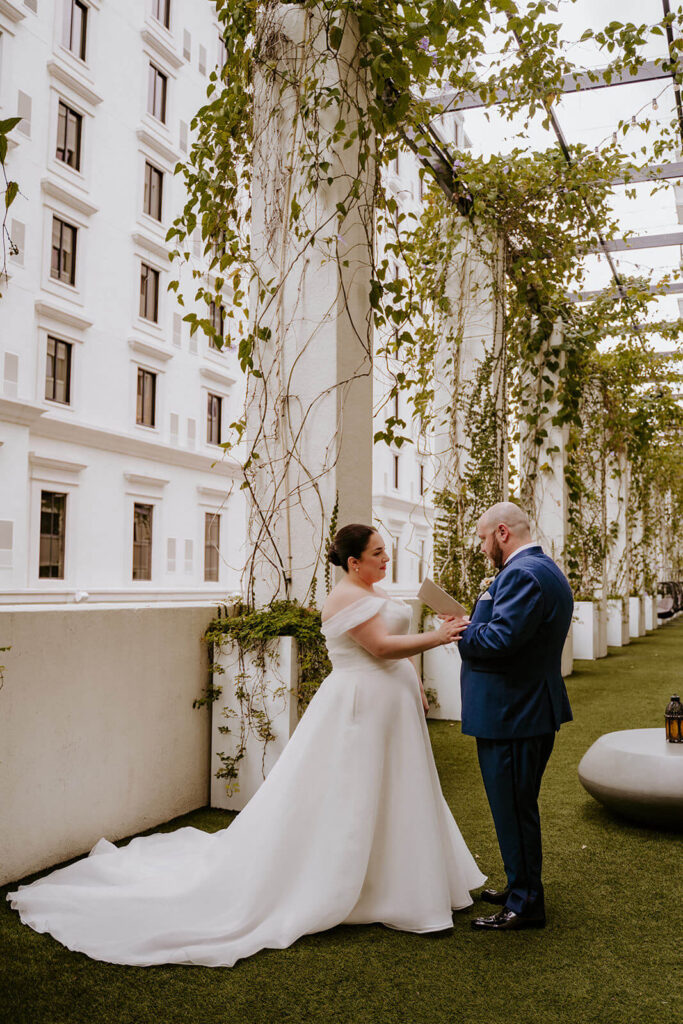 a couple says their vows to each other privately on their wedding day at Thesis Hotel in Miami