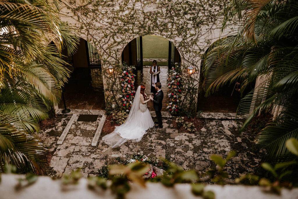 a bride and a groom at their ceremony at Villa Woodbine in Miami