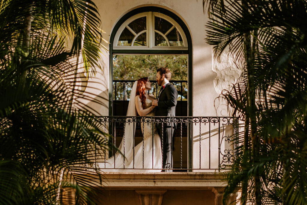 a couple on the balcony in the front of their miami wedding venue