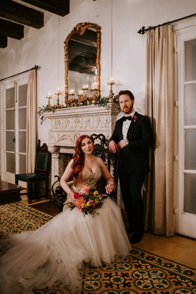 a couple poses in one of the rooms at Villa Woodbine wedding venue