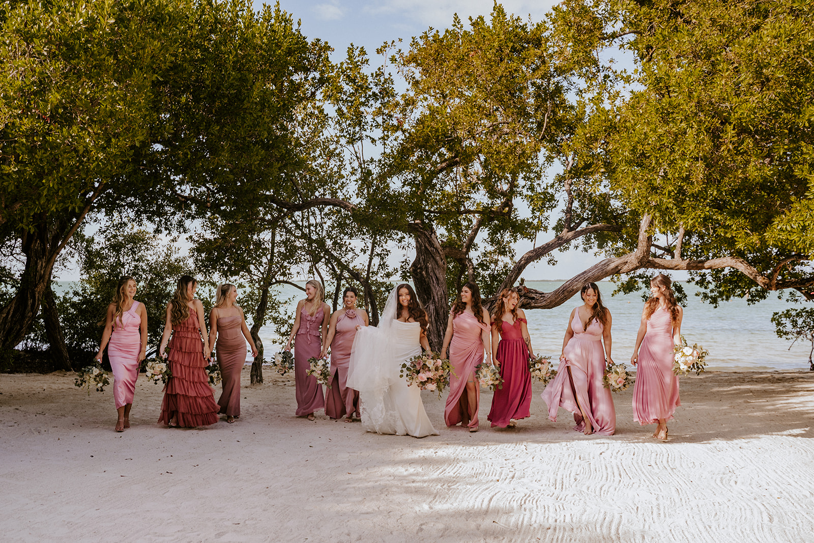 Bridesmaids in dresses in shades of pink