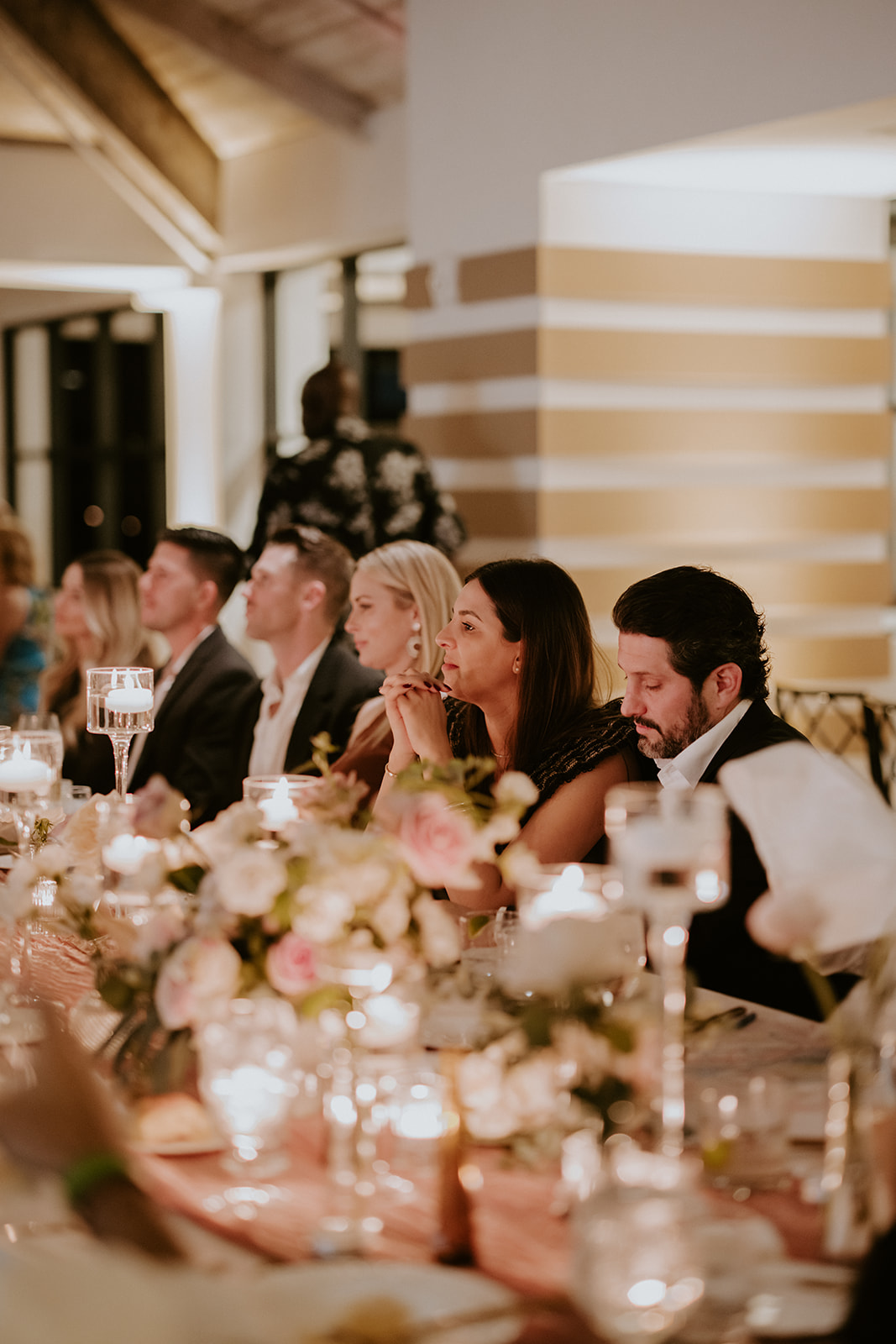 Guests listen to toasts at the South Florida wedding reception