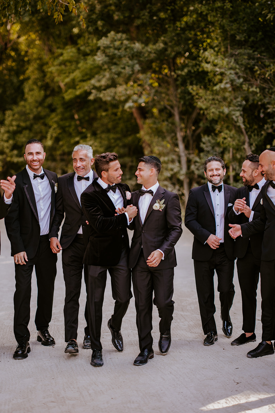 Groom and groomsmen in black tuxedos
