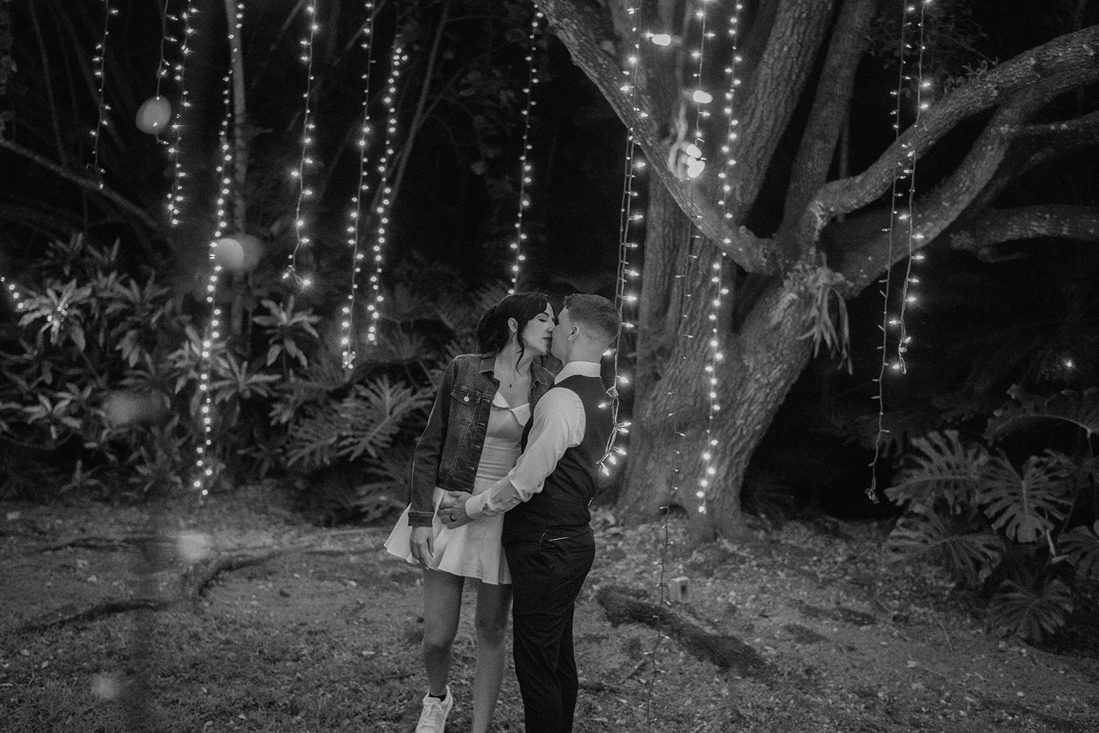 Bride and groom under the string lights at The Cooper Estate