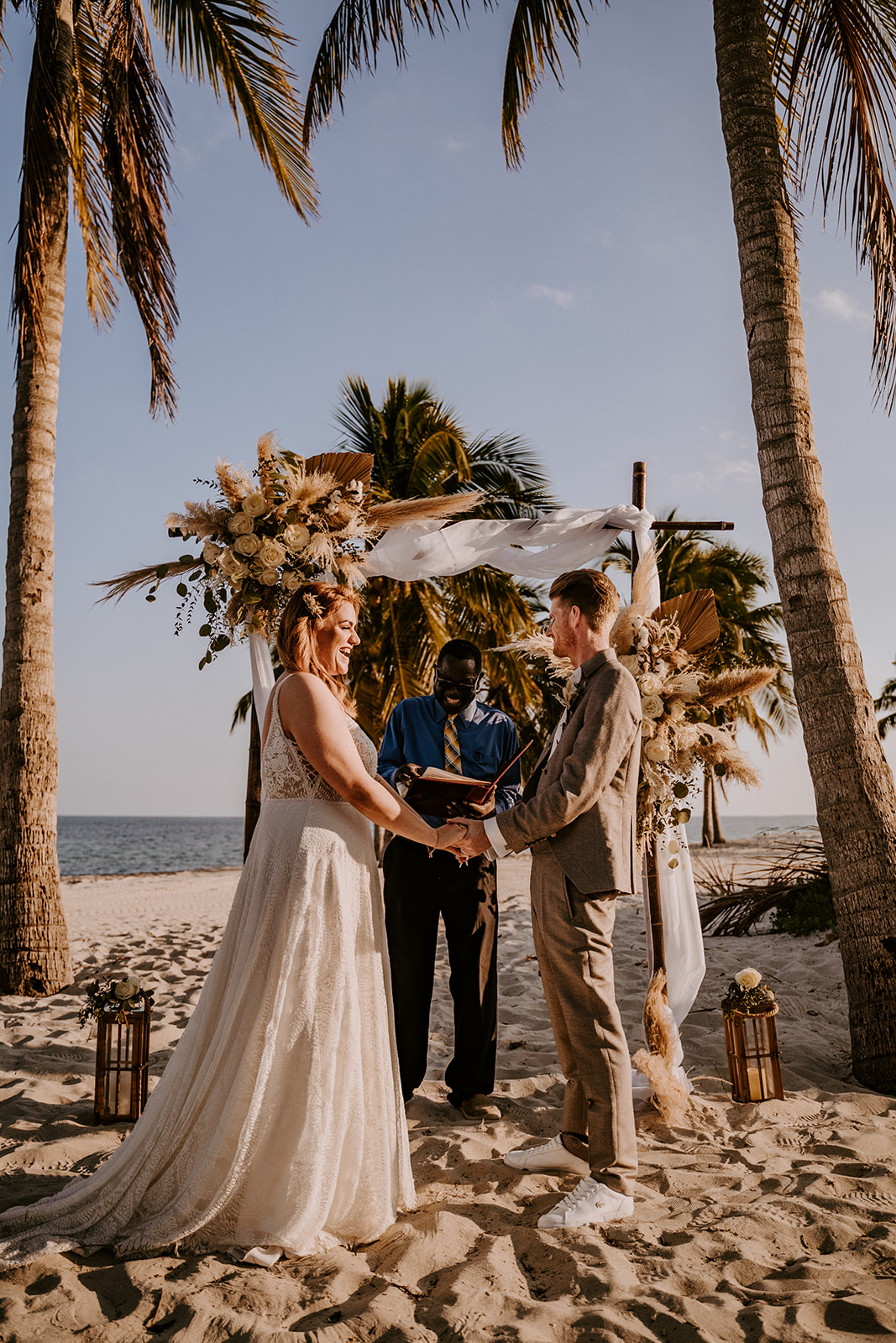 Bride and groom say their vows in a beachside wedding ceremony