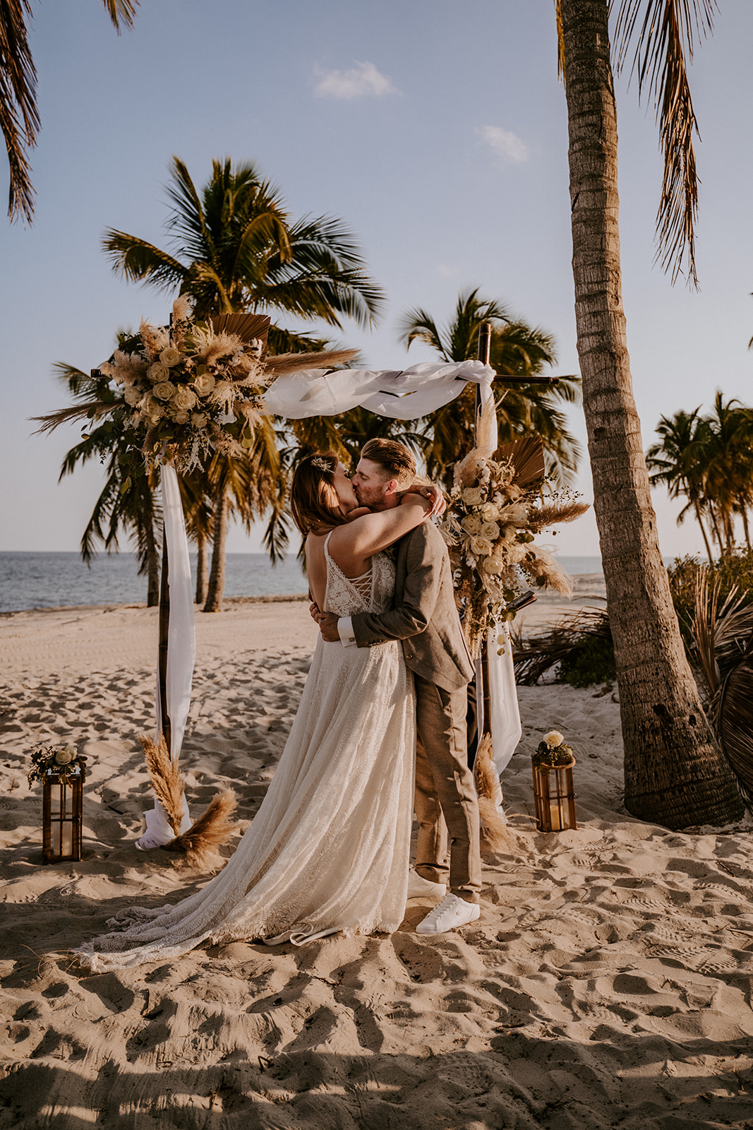 Bride and groom kiss during their Miami wedding ceremony