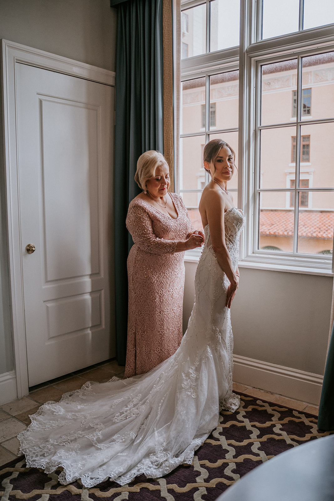 Bride getting into wedding dress before her Miami wedding