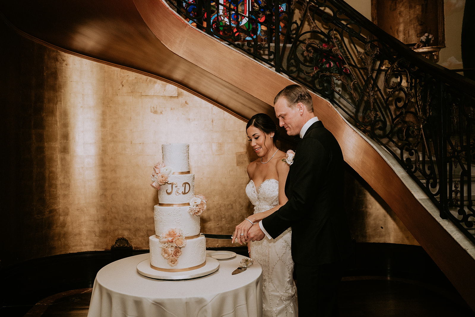 Bride and groom cut wedding cake at The Cruz Building