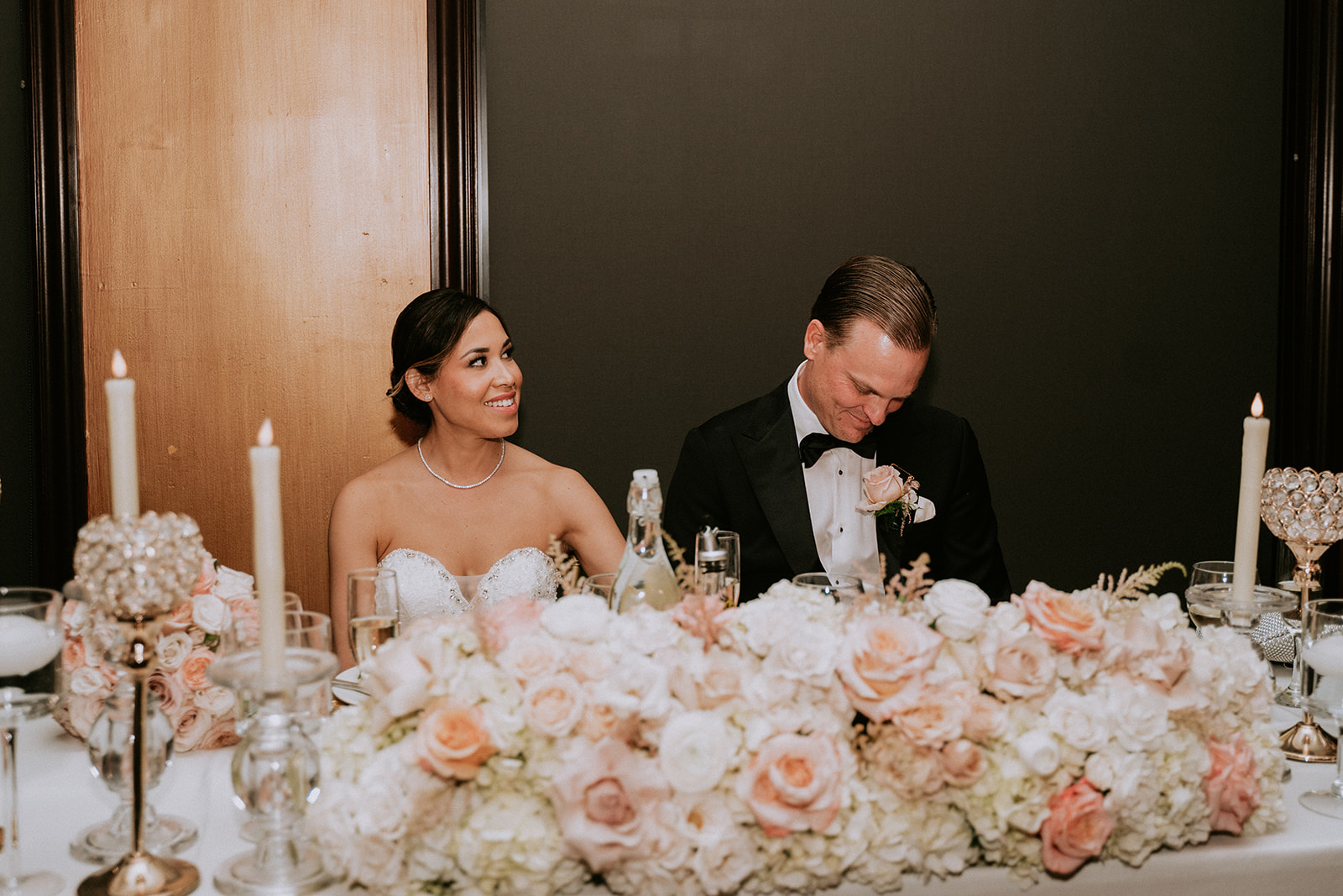 Bride and groom listen to toasts at their Cruz Building wedding