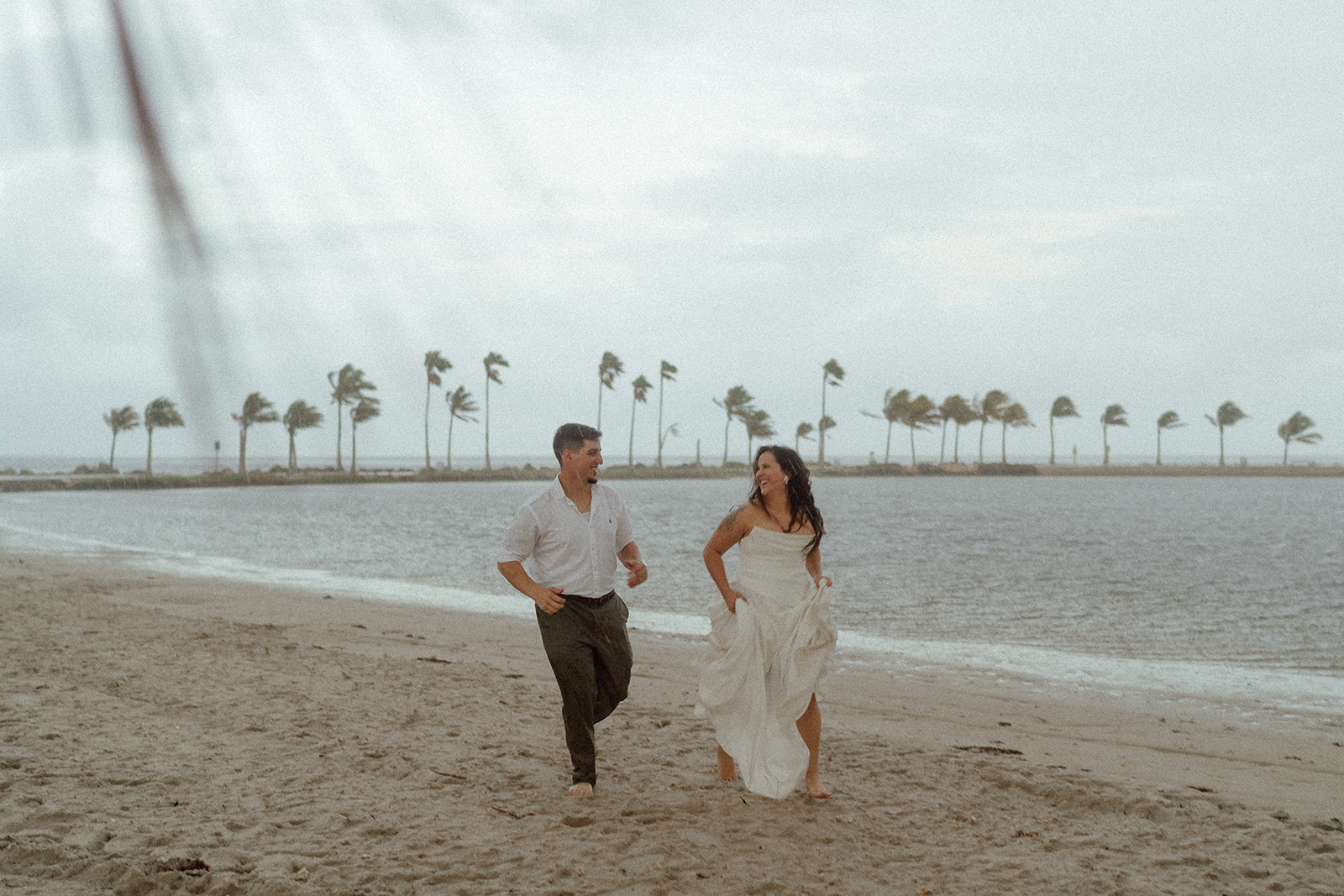 Couple walks on the beach in Miami during engagement session