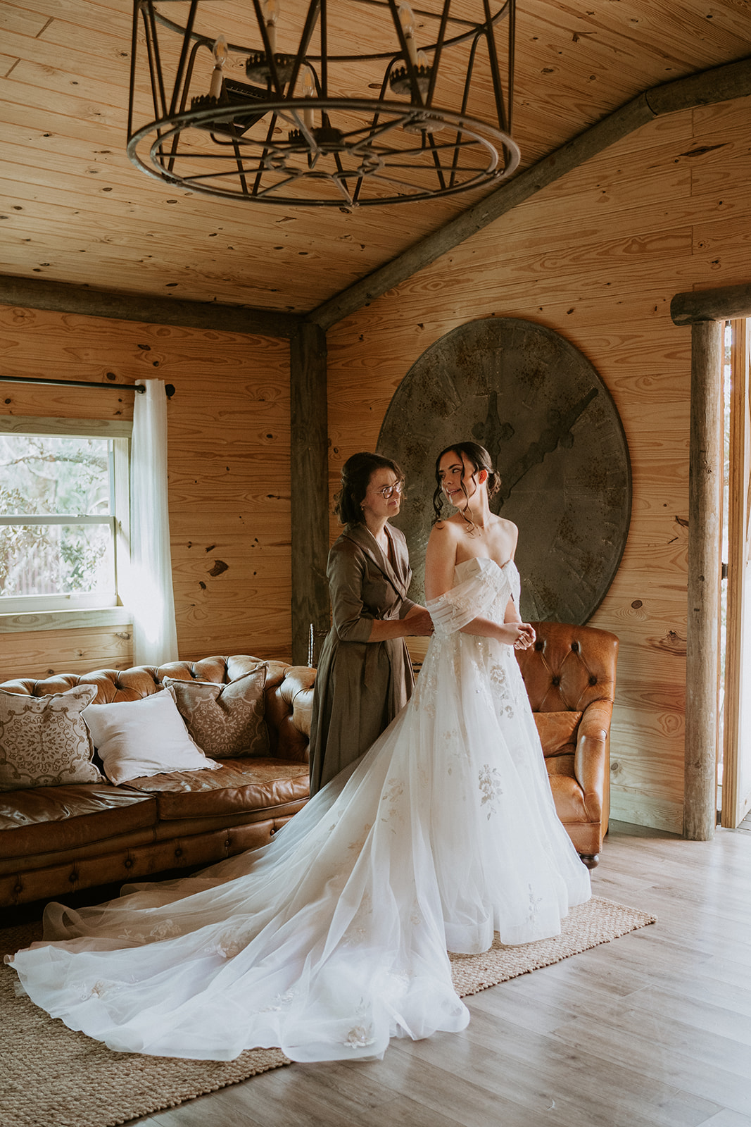 Bride getting into her wedding dress at her Barn 305 wedding