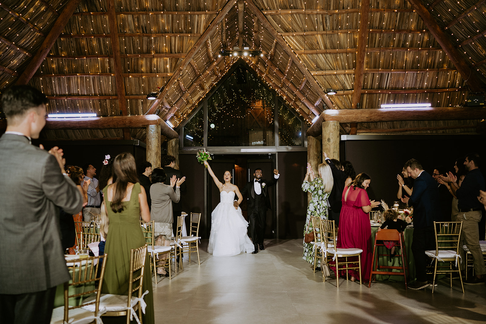 Bride and groom make grand entrance into their Barn 305 wedding reception