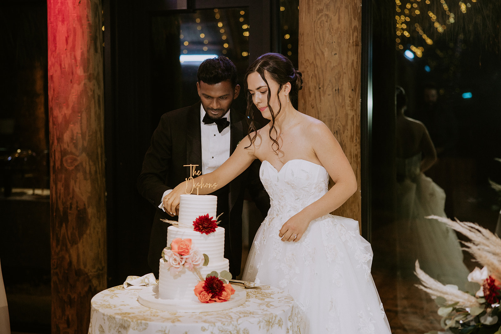 Bride and groom cut their cake at the Barn 305 wedding reception