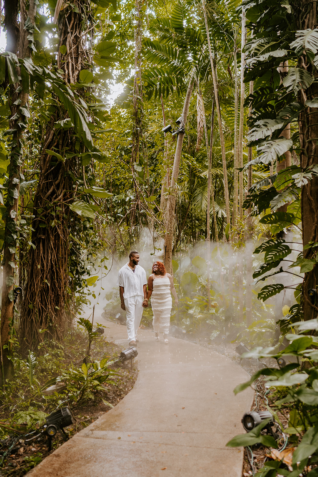 Man and woman walk on path at Fairchild Tropical Botanic Garden