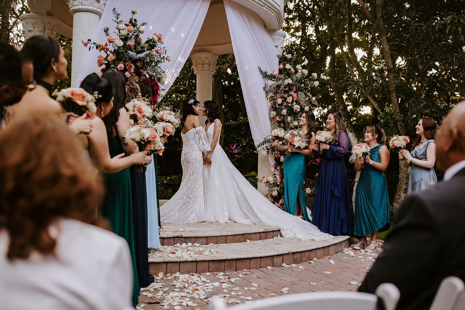 Two brides kiss at Villa Toscana wedding ceremony