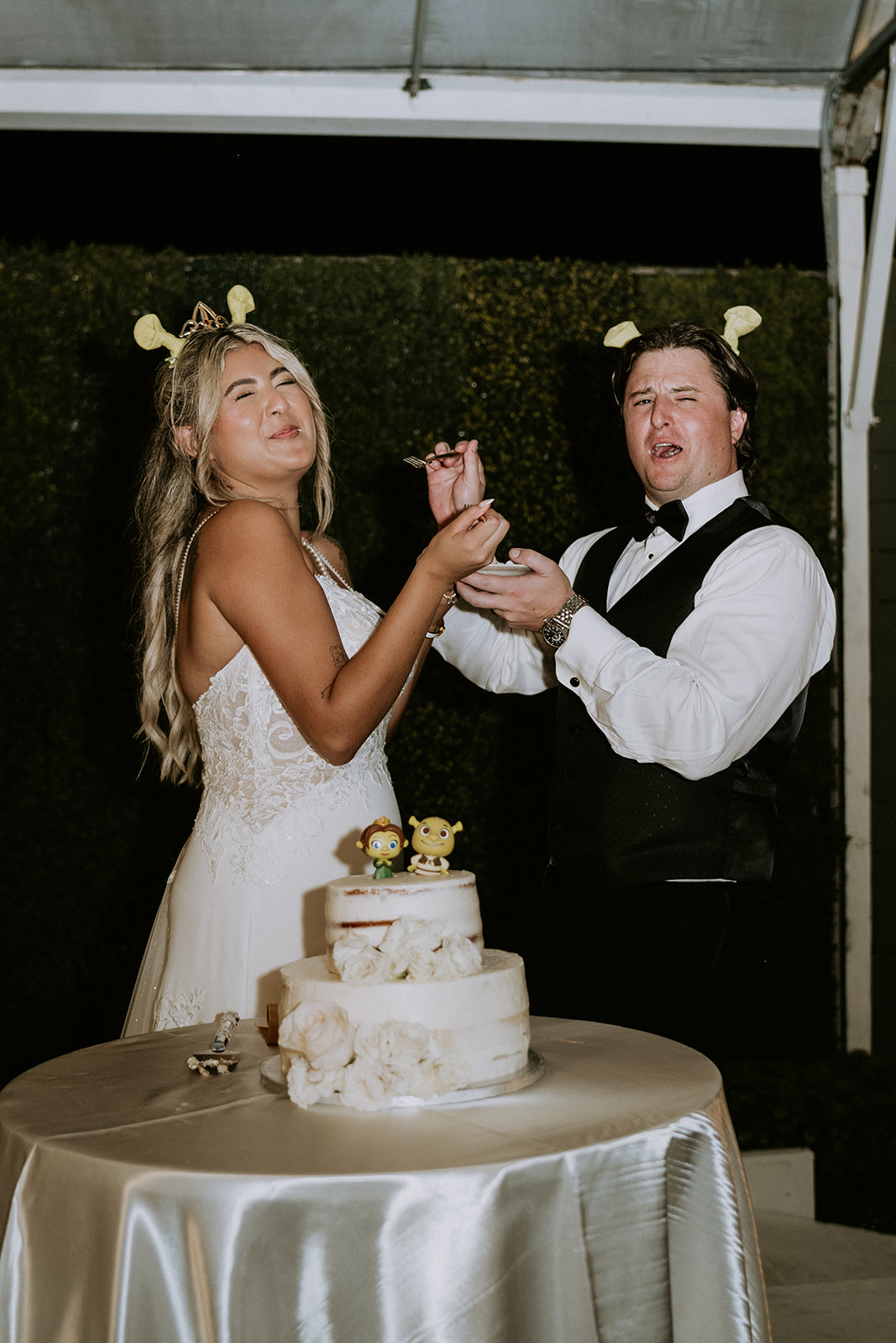 Bride and groom cut their wedding cake at the Vignette Gardens wedding